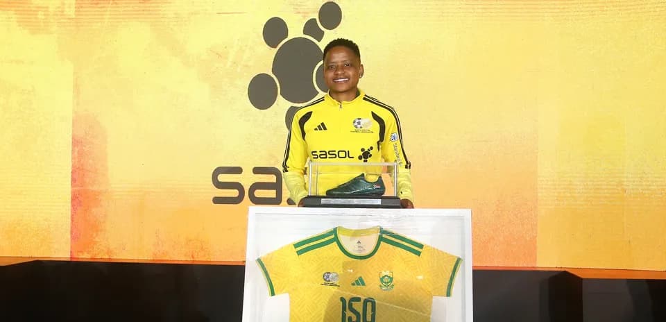 Player presenting commemorative jersey and soccer boot
