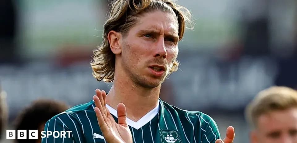 Player applauding fans after a match