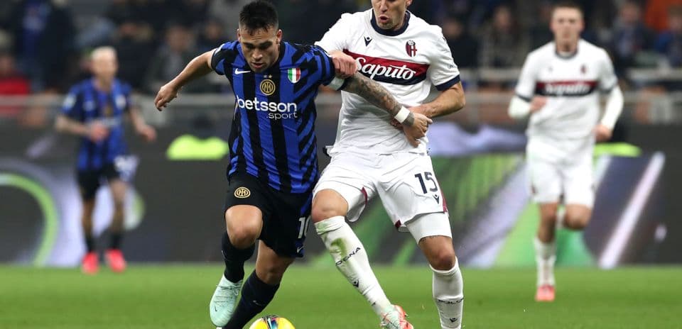 Lautaro Martinez challenged by Bologna defender
