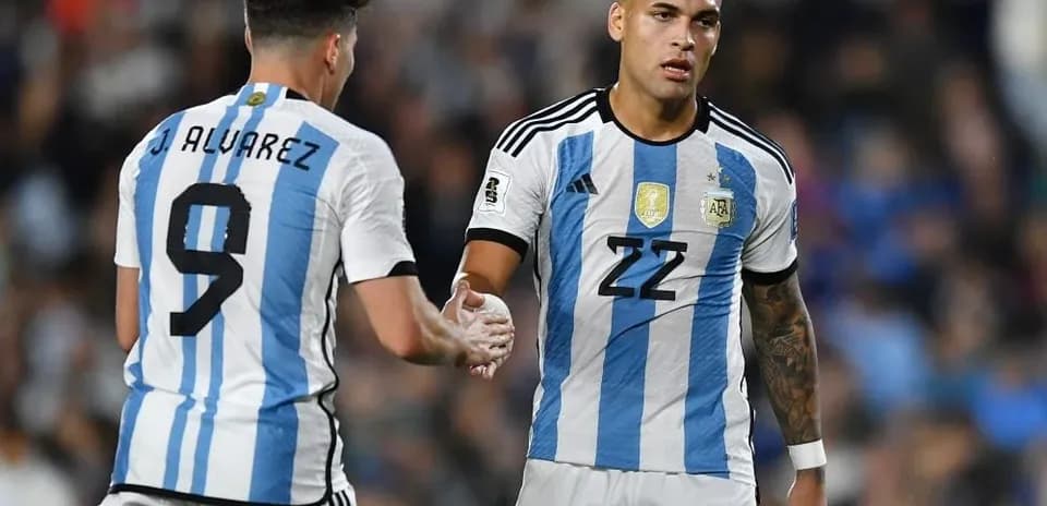 Two Argentine players shaking hands during match