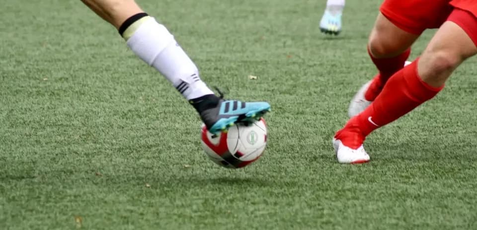 Player kicking the ball on the field
