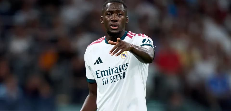 Player gesturing during a match wearing Real Madrid kit