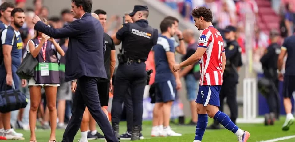 Player leaving field while coach gestures nearby