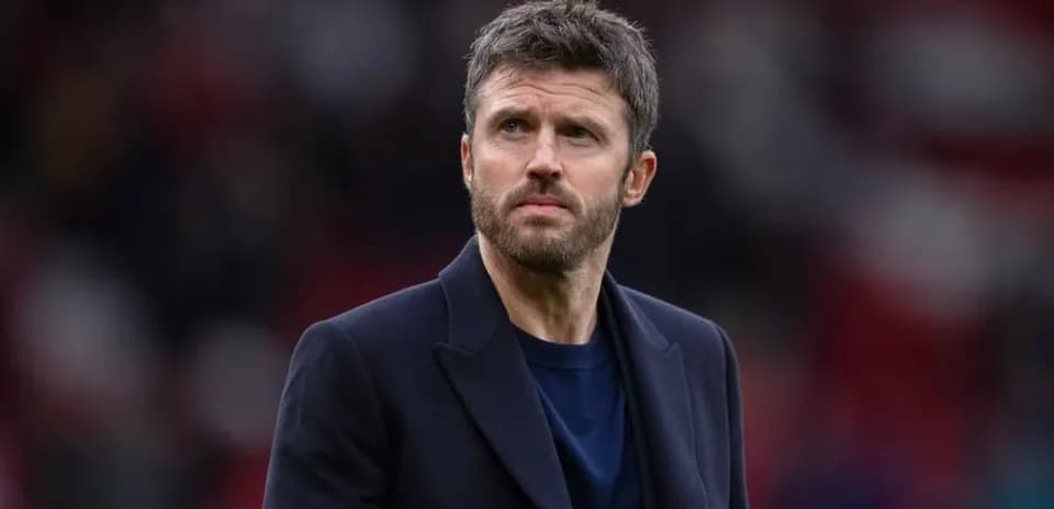Man in a coat on a football pitch