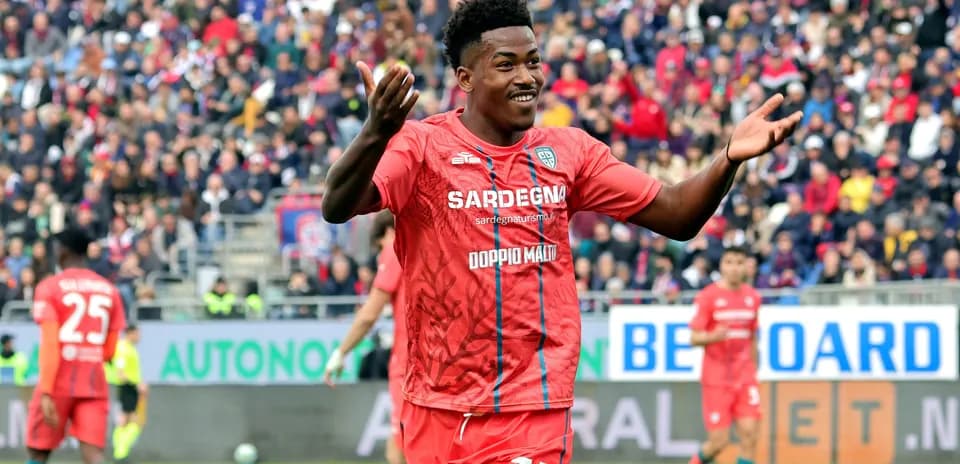 Player celebrating in red team kit during match