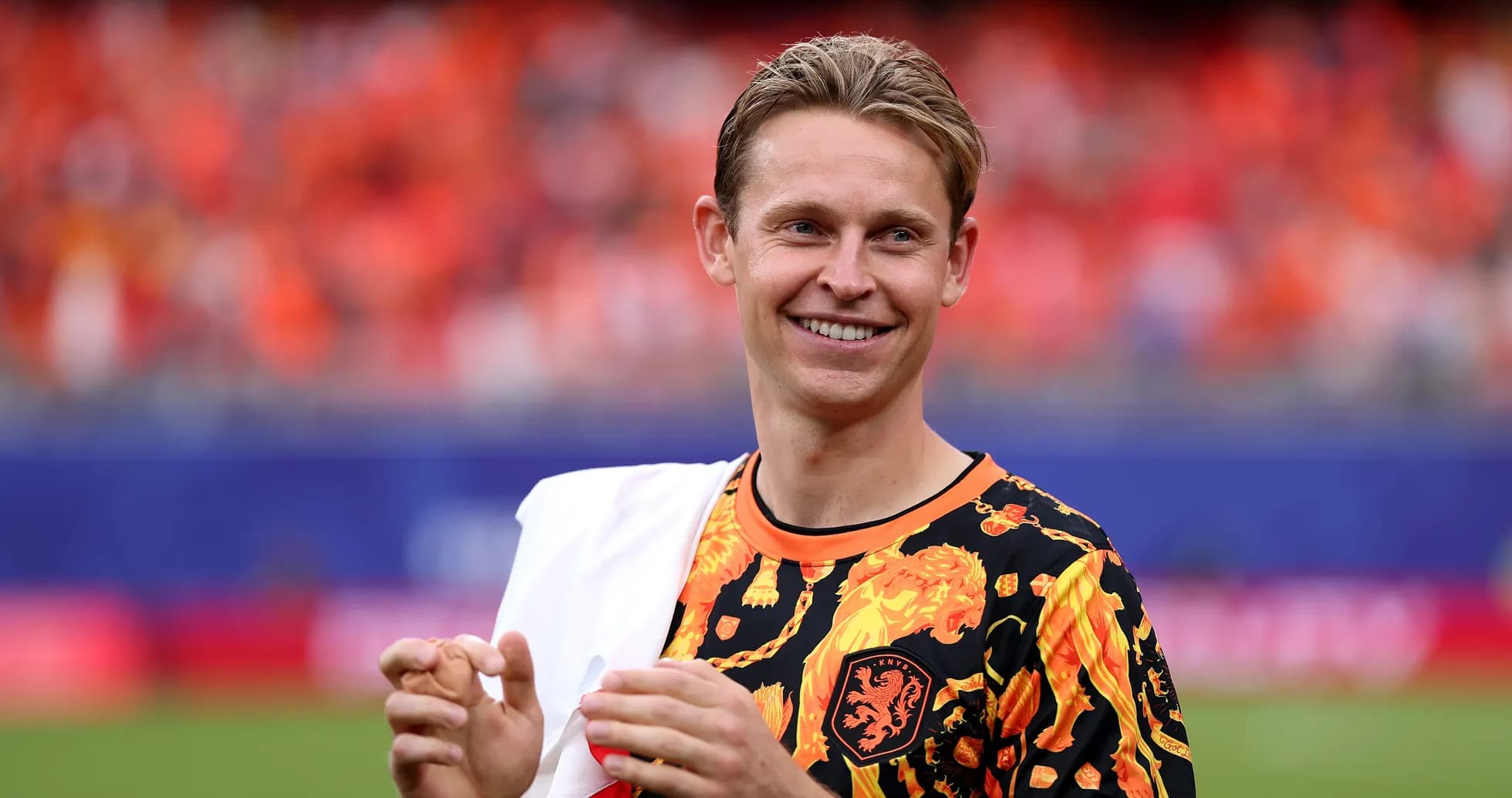 Player smiling in vibrant team-themed attire on field