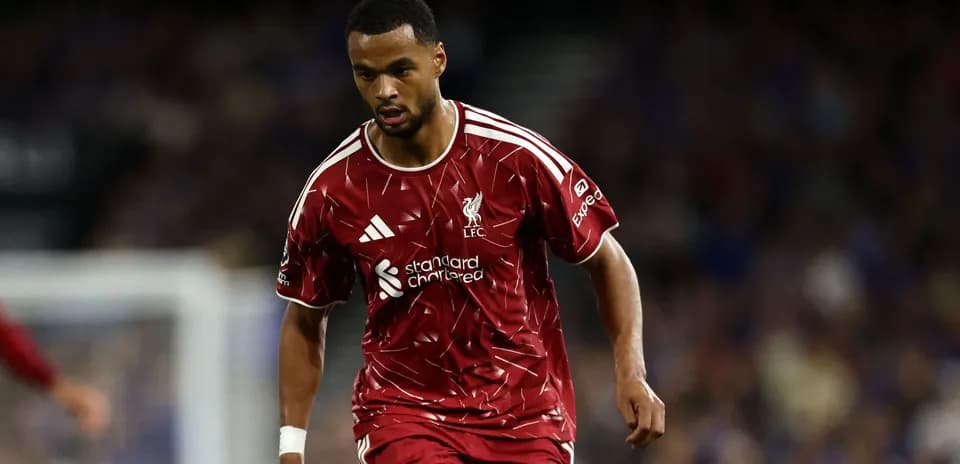 Player in red Liverpool kit running on the field