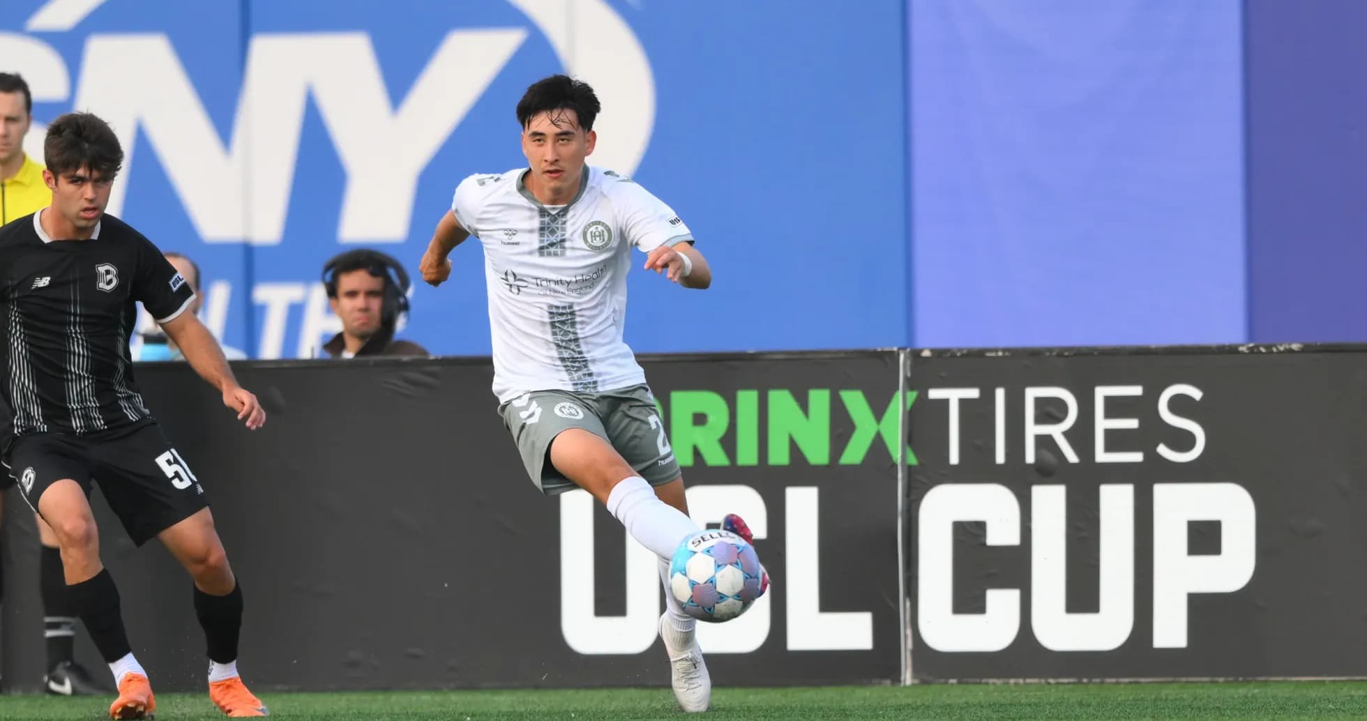 Player dribbling the ball during USL Cup match