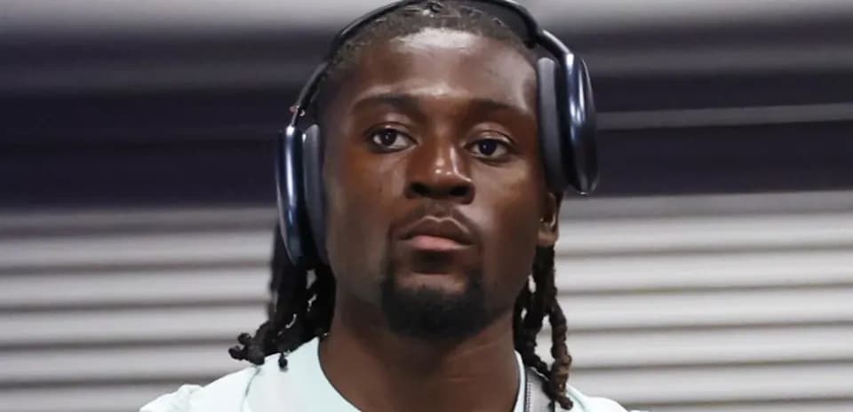 Athlete wearing headphones in a hallway