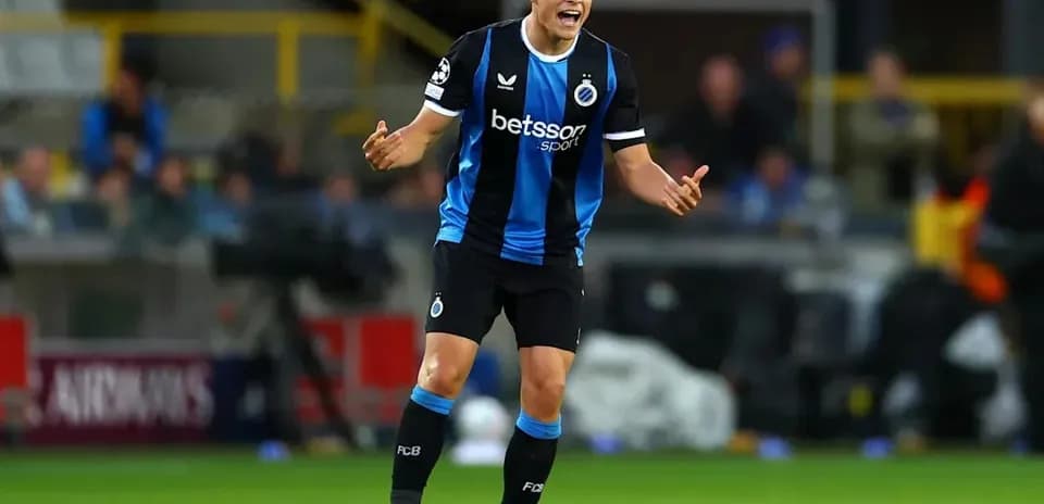 Player in blue and black kit gesturing during match