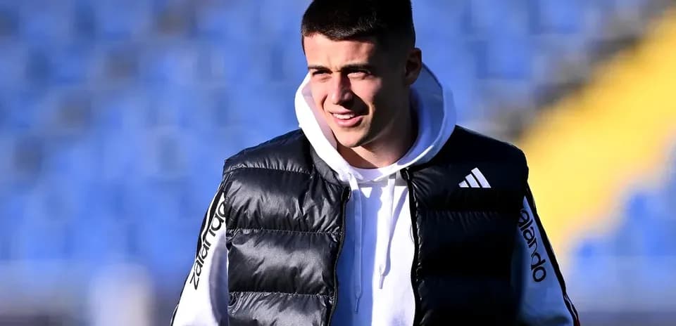 Player in puffer vest at training ground