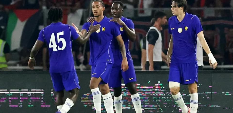 Players celebrating a goal on the field