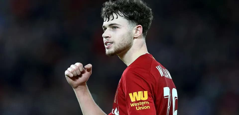 Player celebrating during match in Liverpool kit