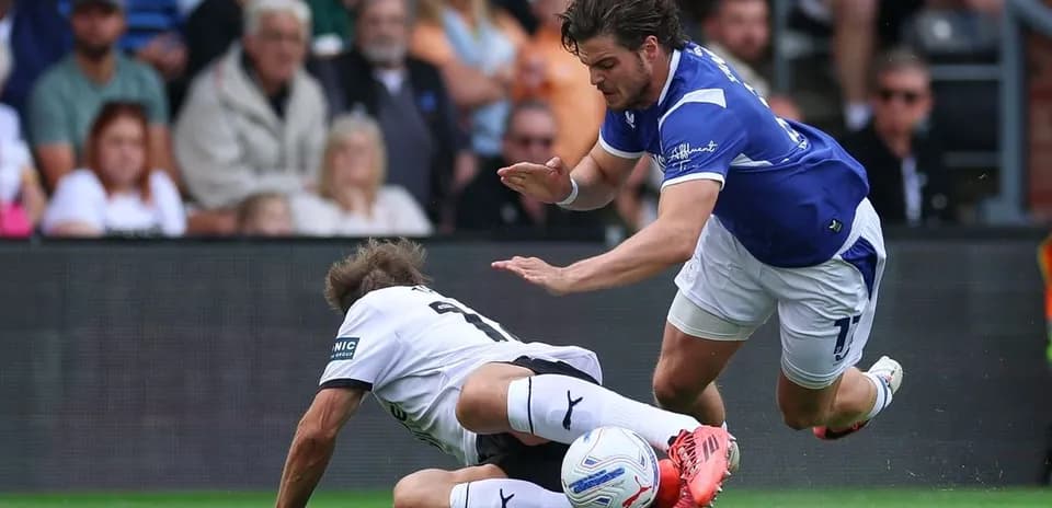 Player tackling opponent during a football match
