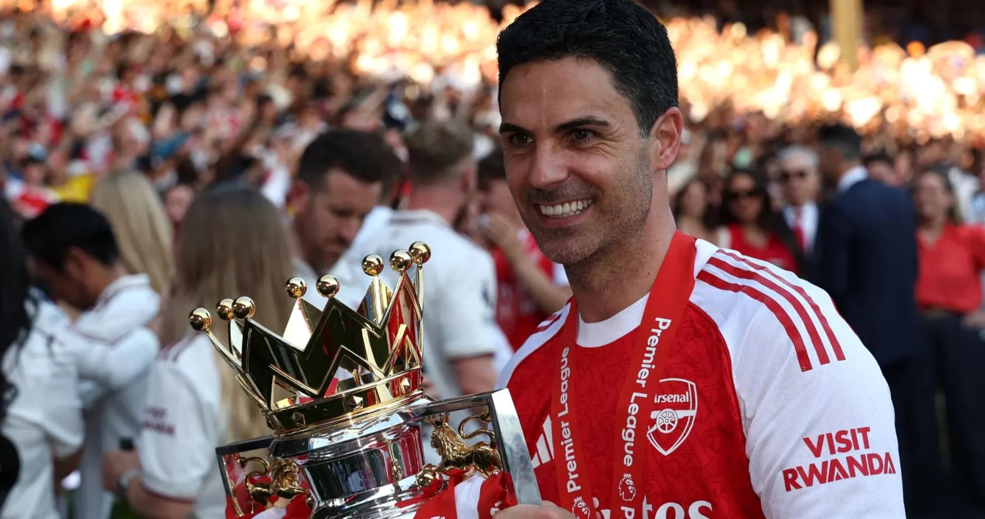 Manager holding Premier League trophy at celebration