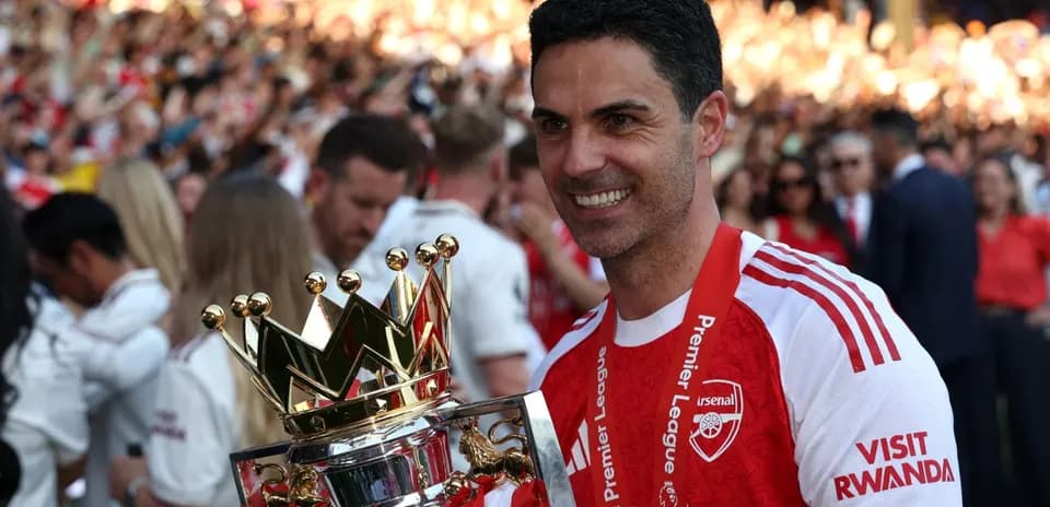 Manager holding Premier League trophy at celebration
