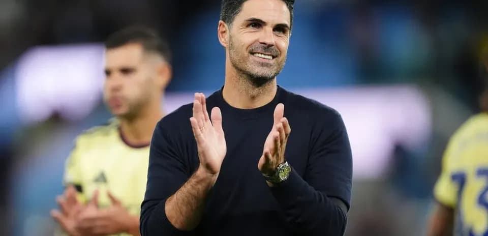 Coach clapping during post-match celebration