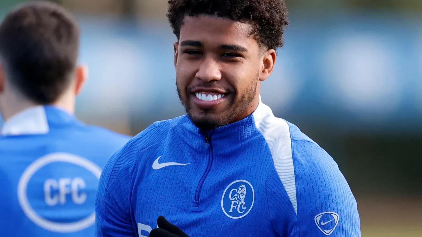 Player smiling during training session in blue kit