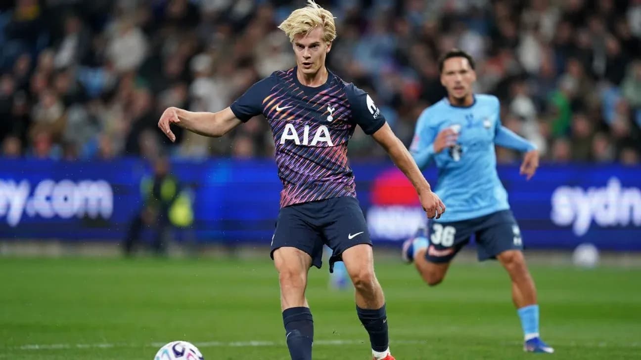 Player in Tottenham kit passing ball during match