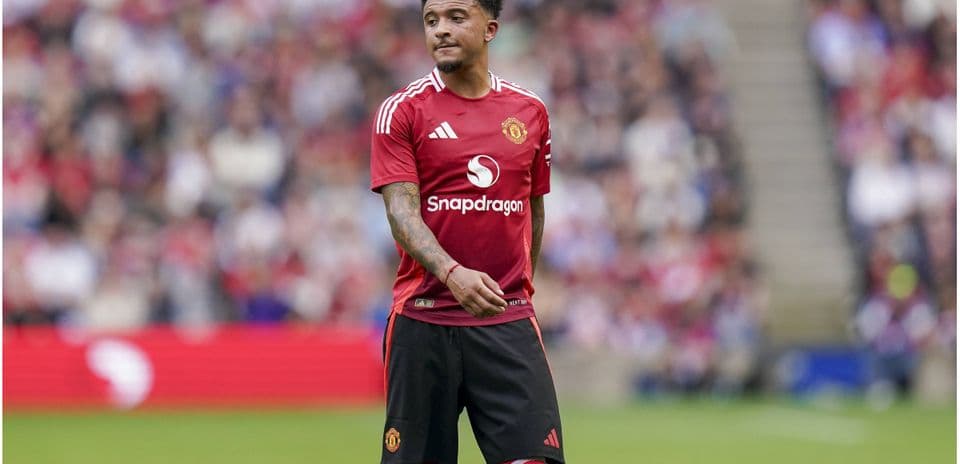 Player in Manchester United jersey on the pitch