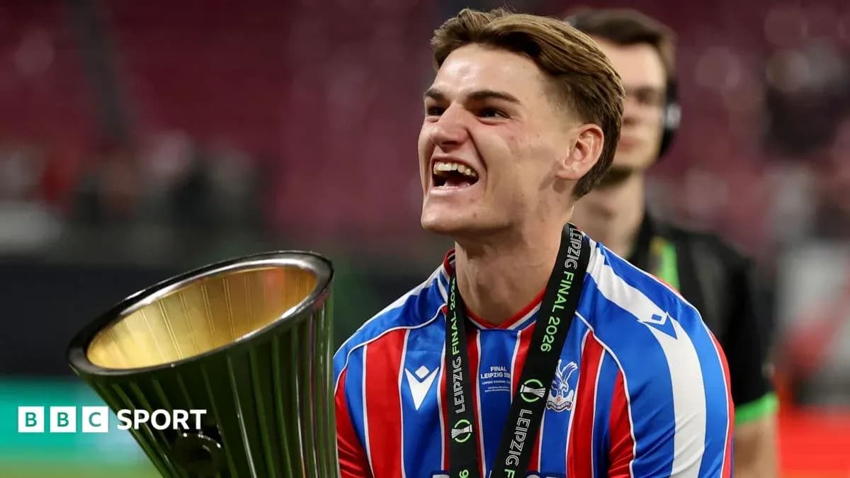 Player celebrating with trophy after winning final