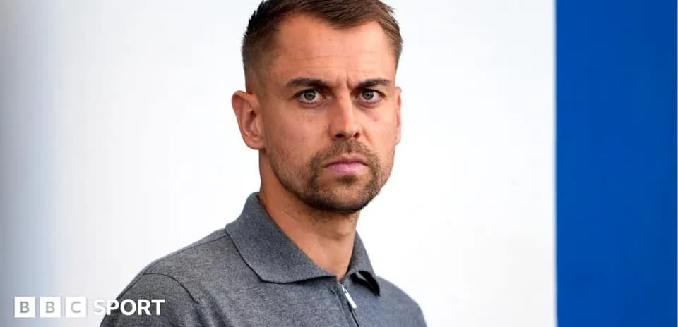Person with short hair in gray polo shirt