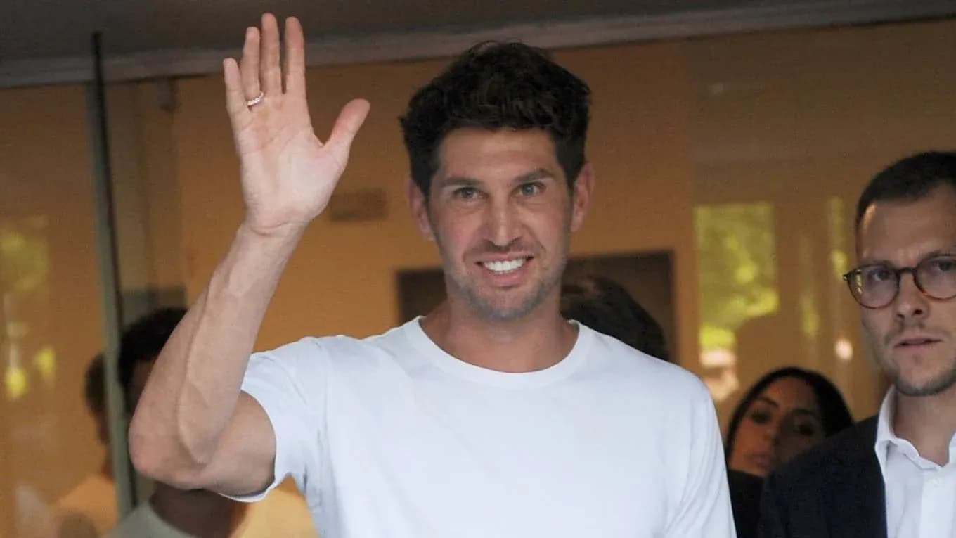 Person waving while standing with others