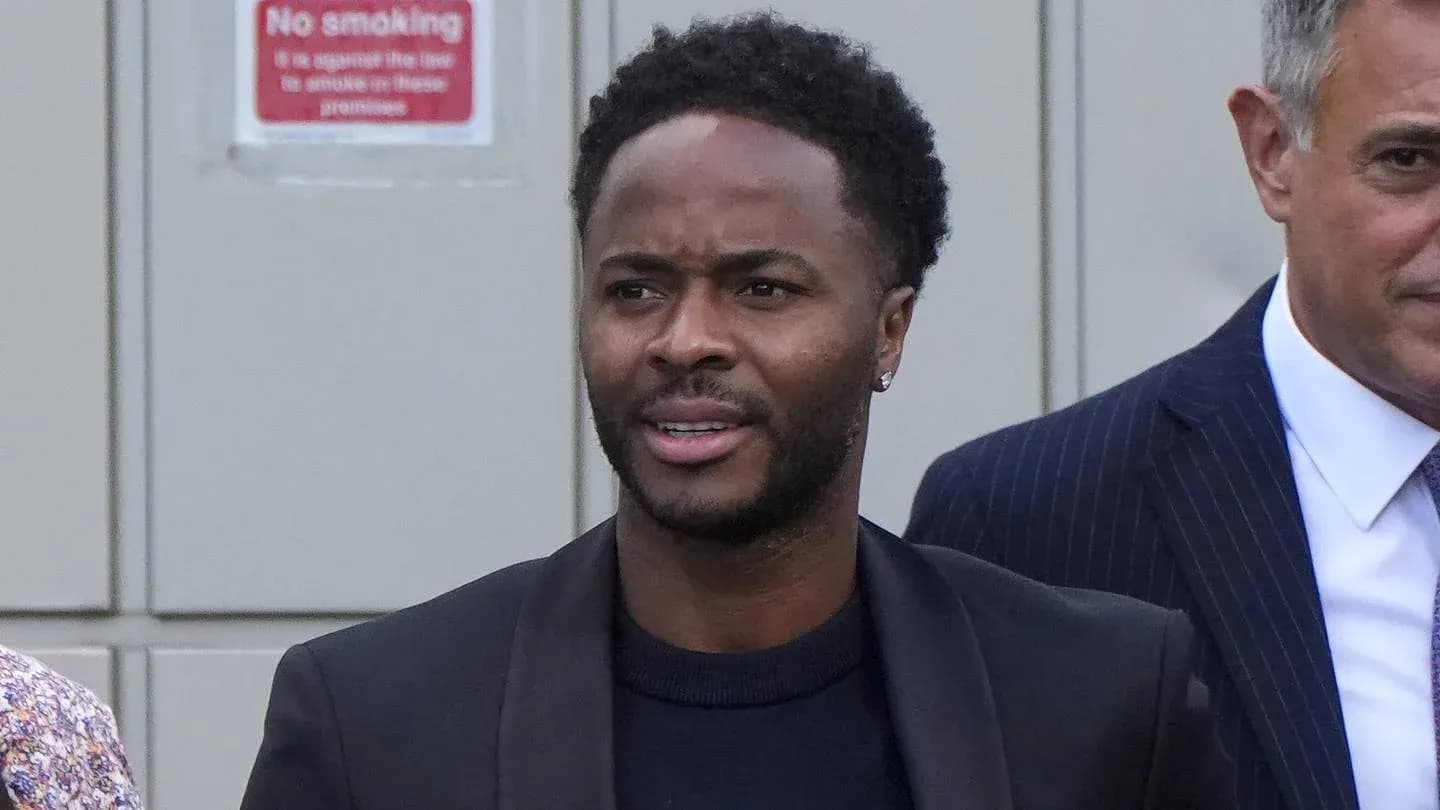 Man in black jacket walking with another person