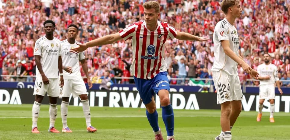 Atletico Madrid player celebrating a goal against Real Madrid