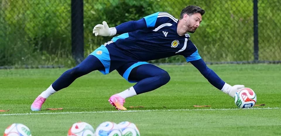 Goalkeeper diving to catch a soccer ball during training