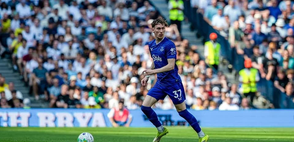Player in blue kit running on the field
