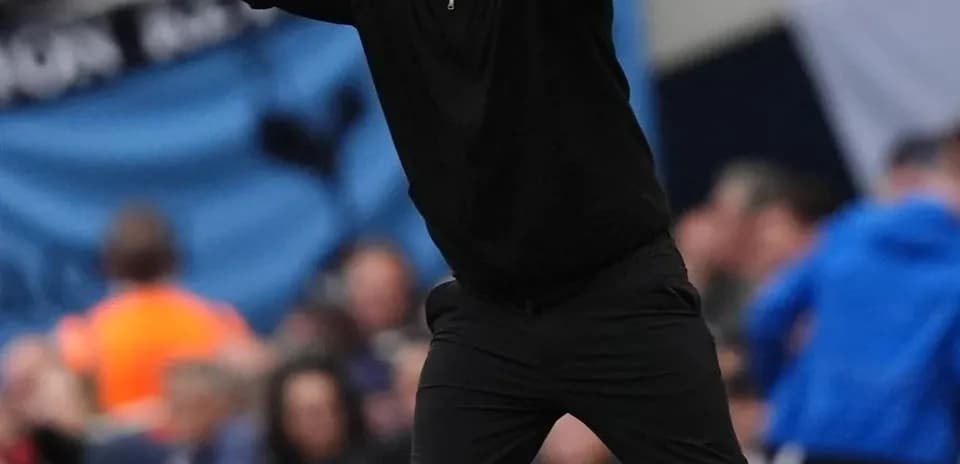 Coach gesturing on the sideline during match