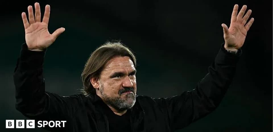 Manager gesturing to crowd after match conclusion