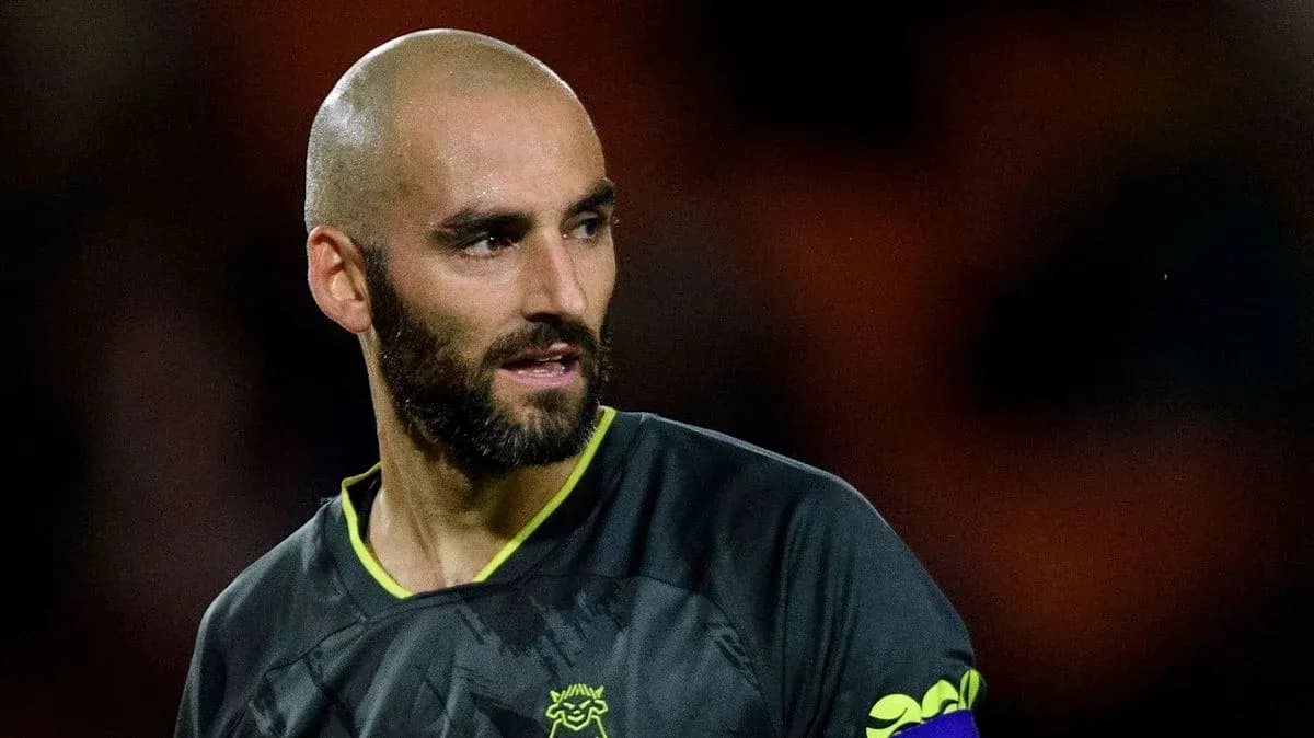 Goalkeeper wearing black kit during match