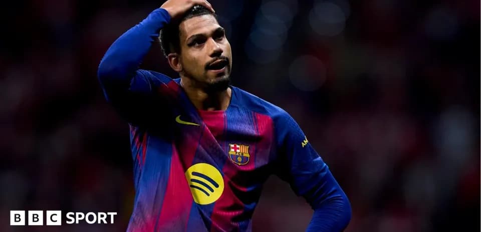 Barcelona player holding head in disappointment on field