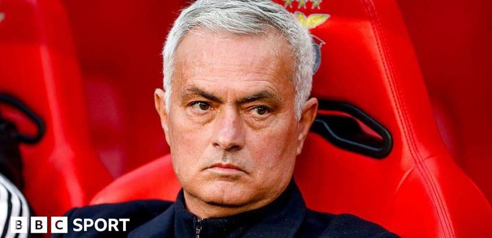 Manager seated on bench during match