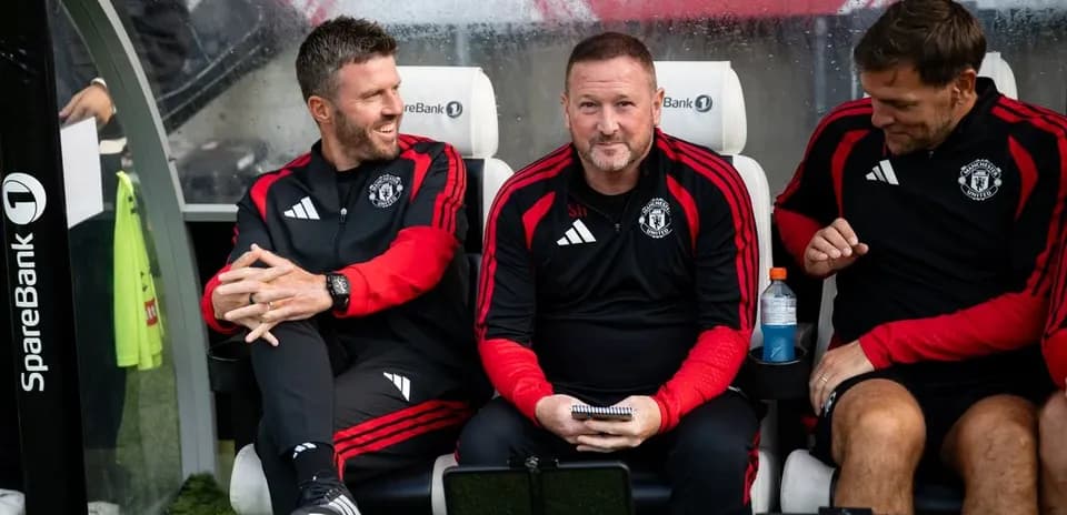 Coaching staff sitting on bench during match