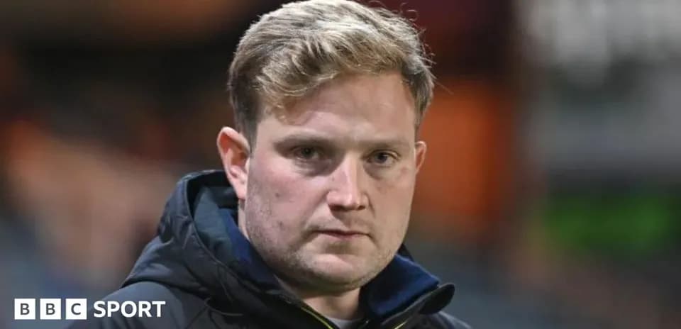 Coach on sidelines during match preparation
