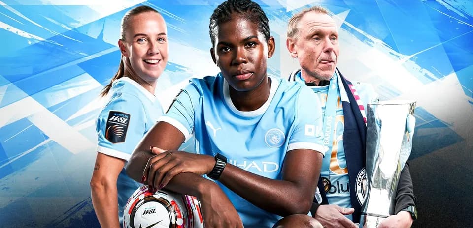 Three Manchester City players posing with trophy