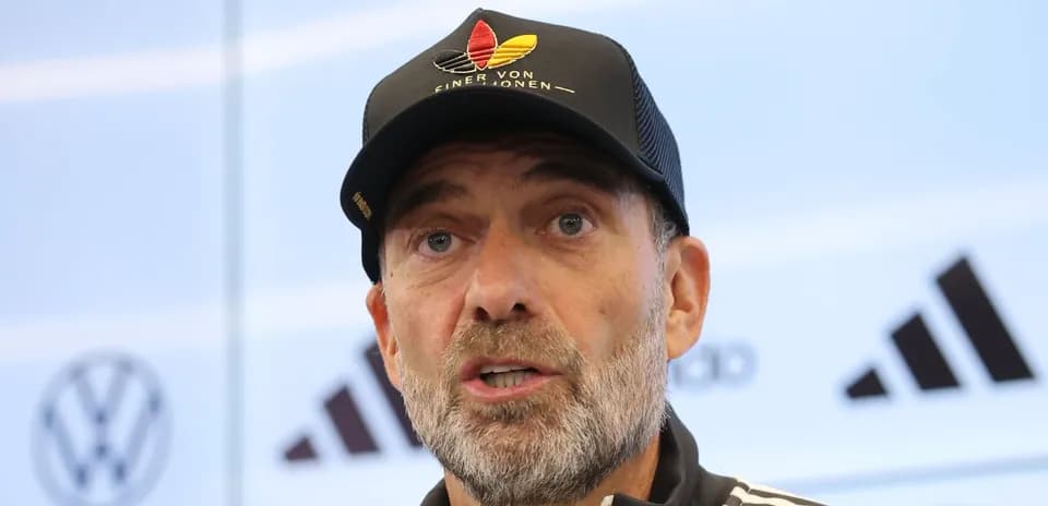 Manager speaking at press conference with microphone