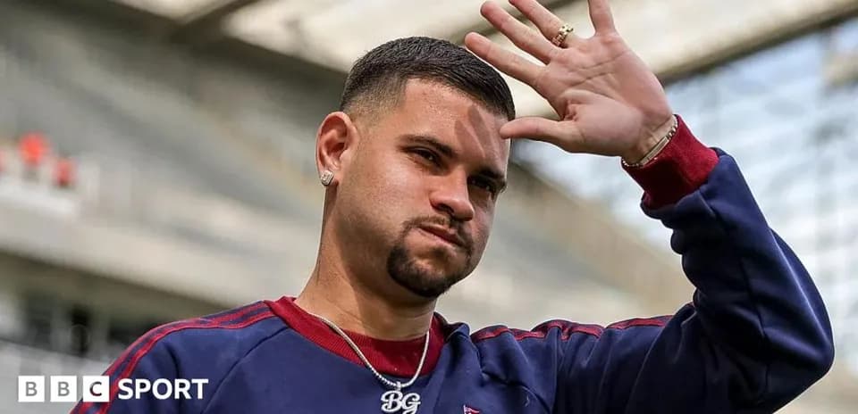 Player waving while wearing team tracksuit