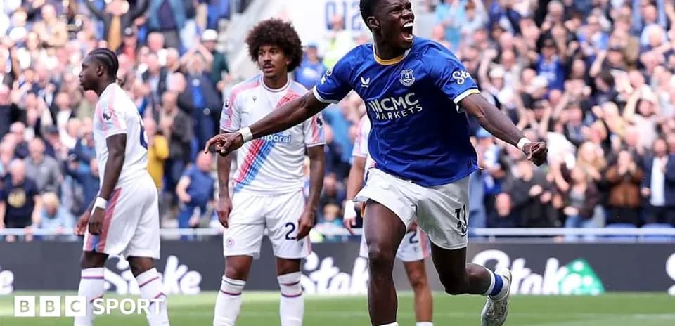 Everton player celebrating goal with teammates in match
