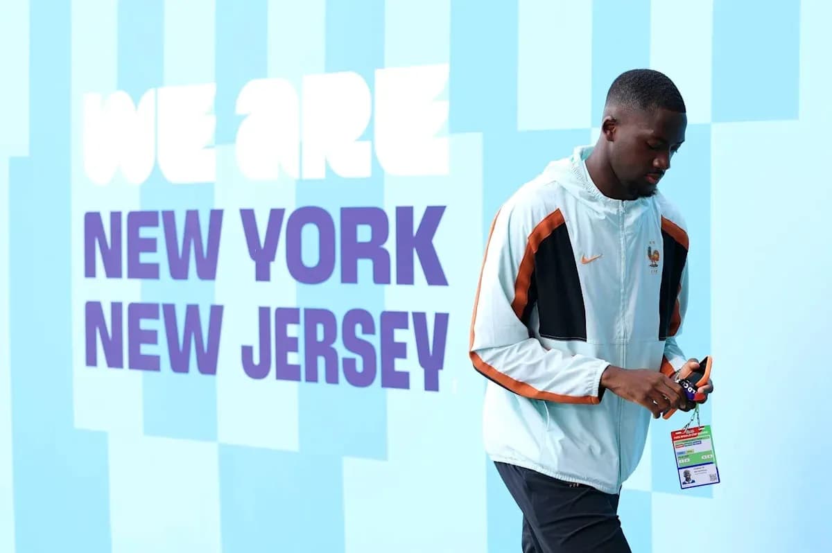 Player walking by 'We Are New York New Jersey' sign