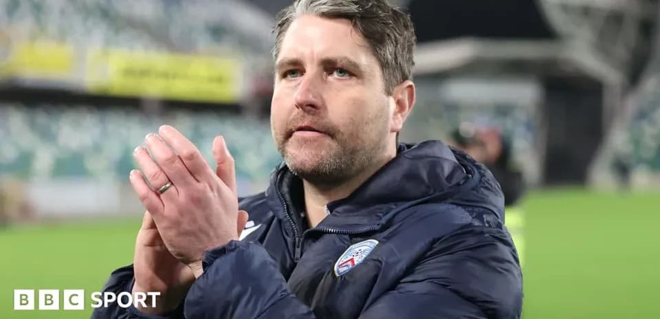 Coach applauding fans after match at stadium