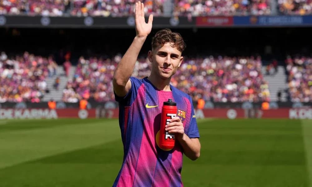 Player waving with water bottle at stadium