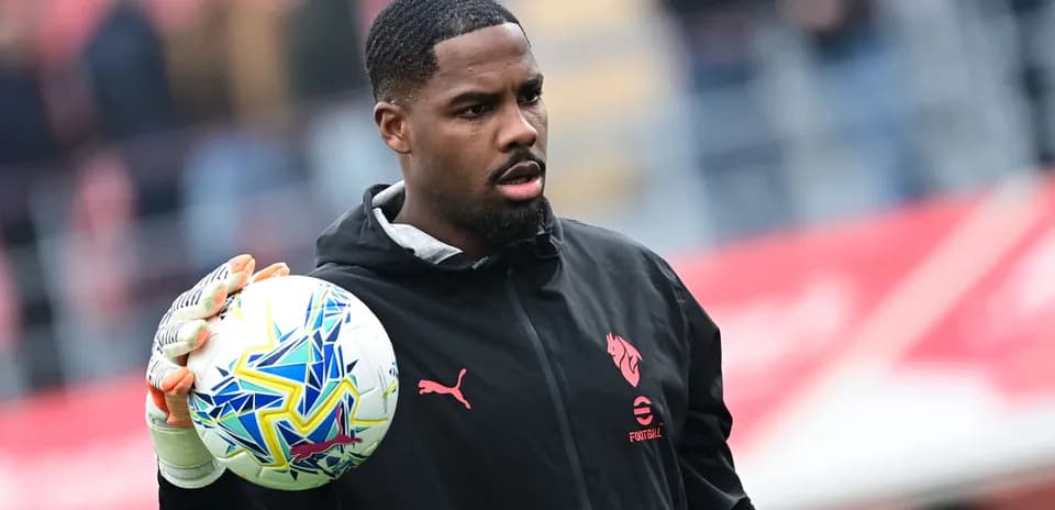 Goalkeeper holding a colorful football before match