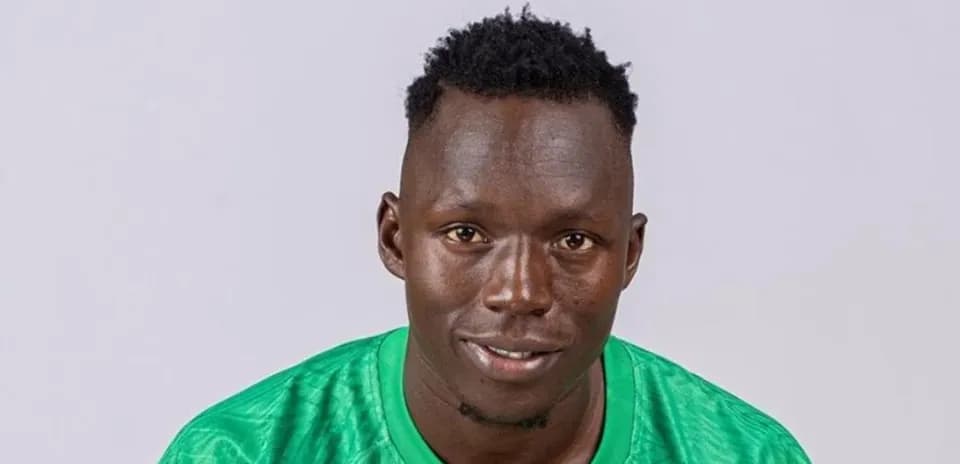 Player posing in green jersey against plain background