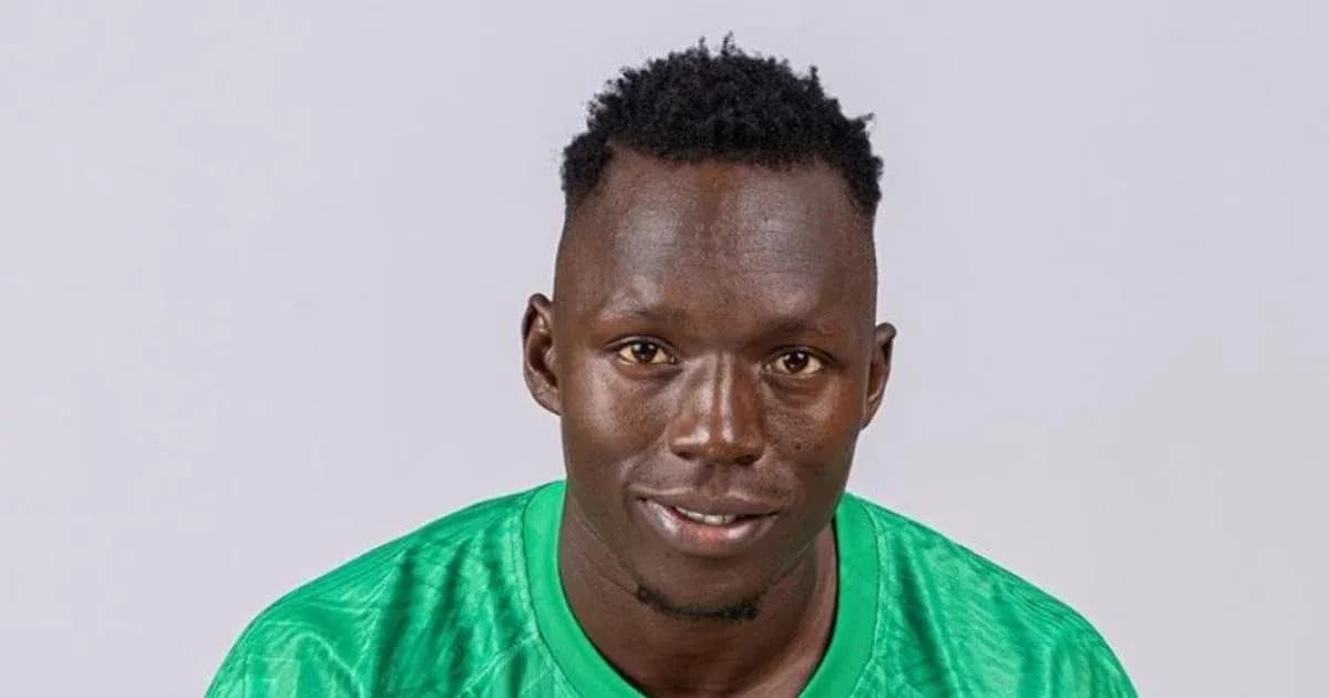Player posing in green jersey against plain background