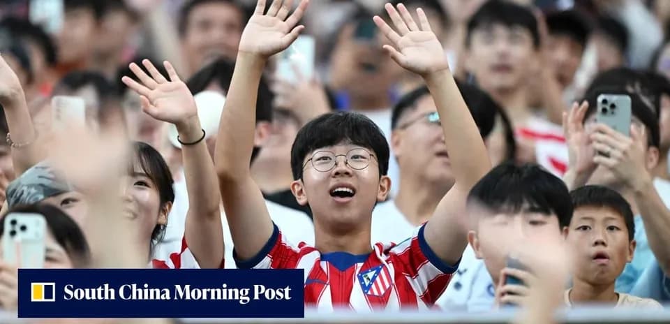 Fan wearing Atletico Madrid jersey cheering in crowd