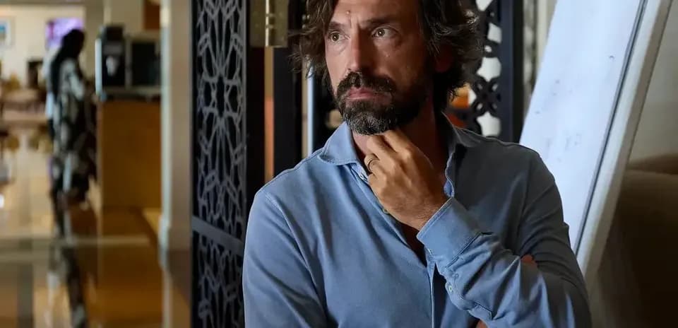 Man with beard in a blue shirt, thoughtful expression